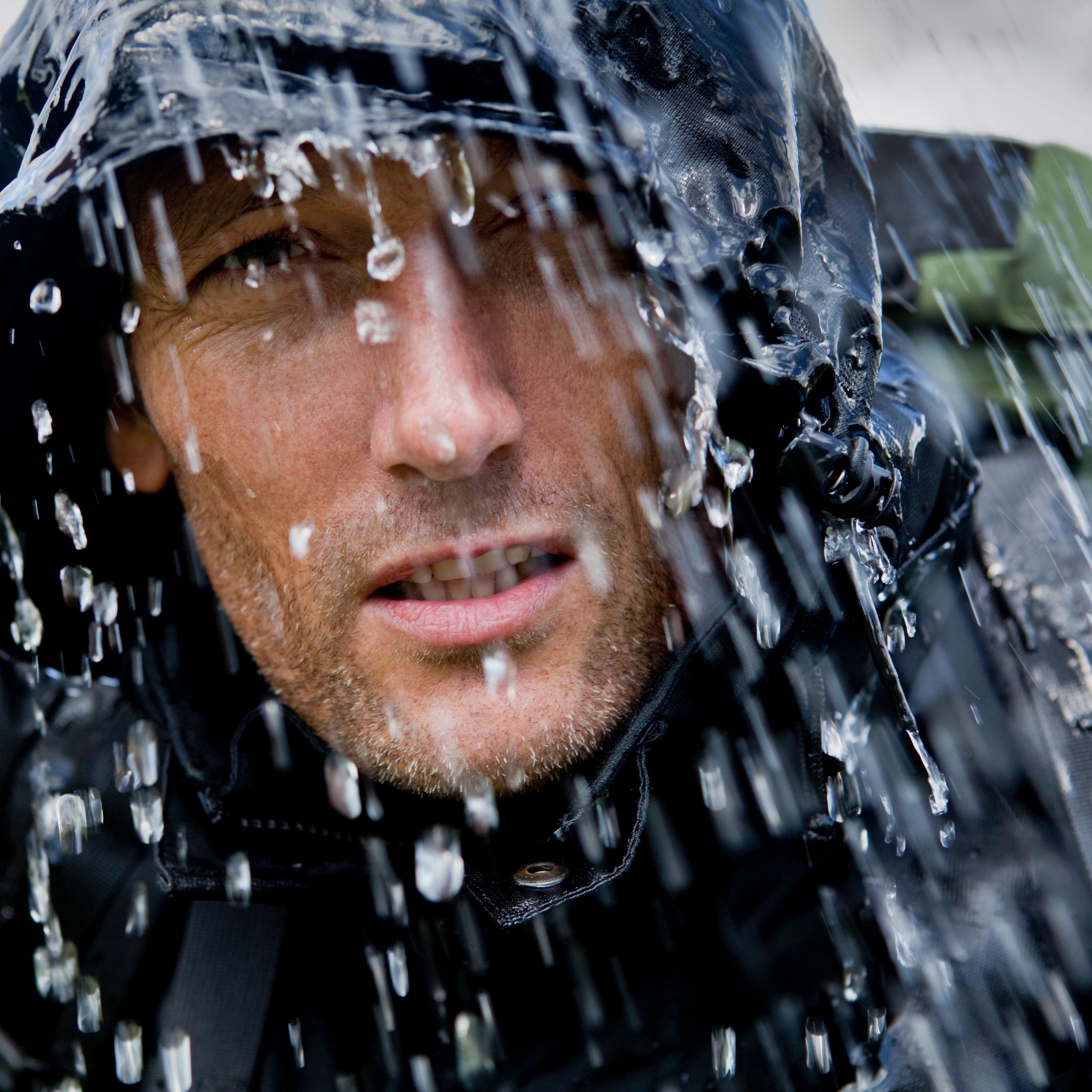 Rain-soaked hiking adventurer wearing storm protection