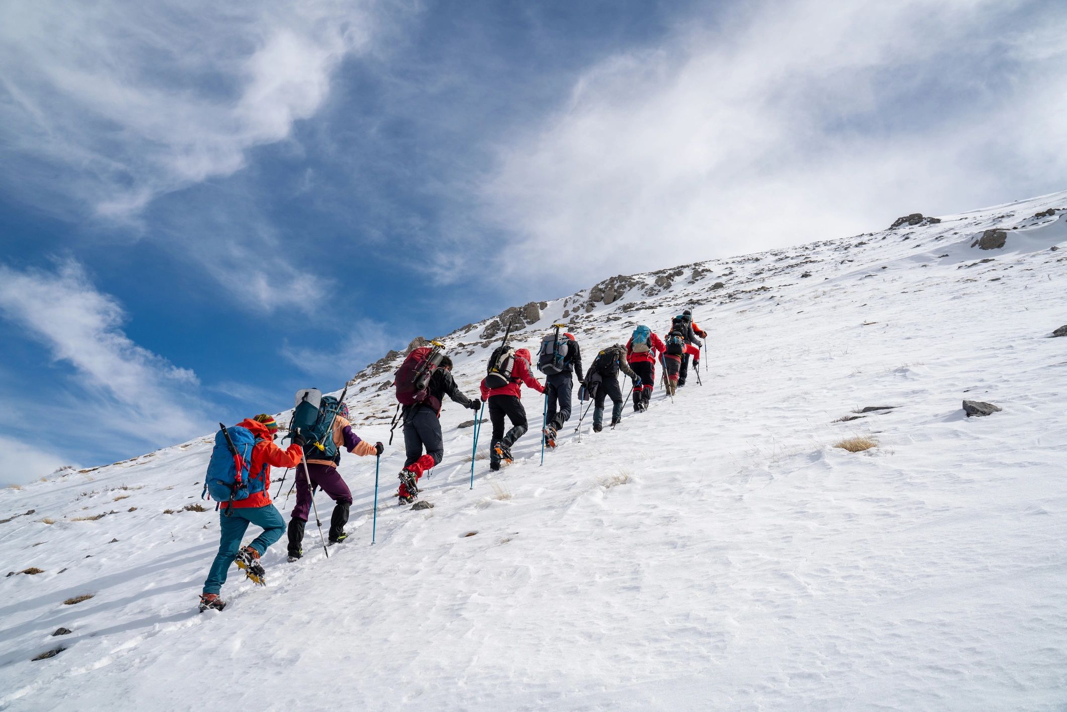 Group of trekkers walking along a mountain ridge