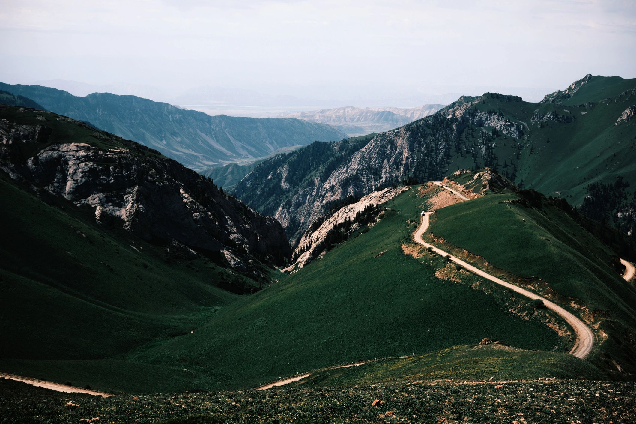 Winding trail or road leading to a mountain pass