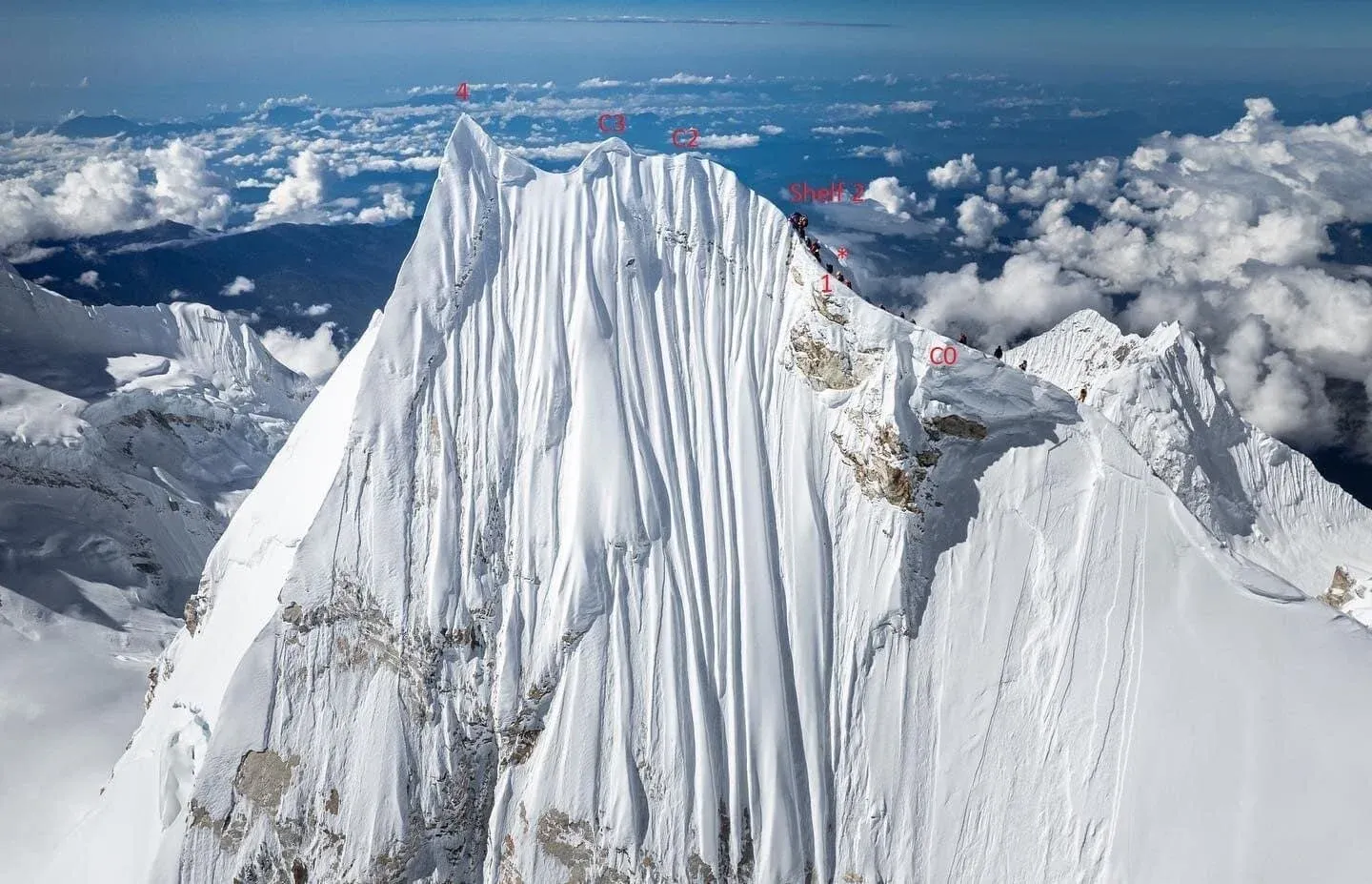 Aerial view of Manaslu's snowy summit with climbing routes and high camps marked, showing the upper glacier terrain and summit ridge approach for autumn expedition planning