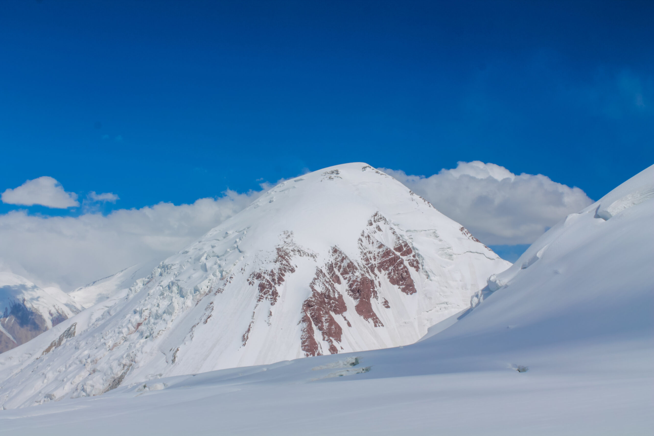 Snow-covered 7,000-metre peak of the Pamir under clear sky