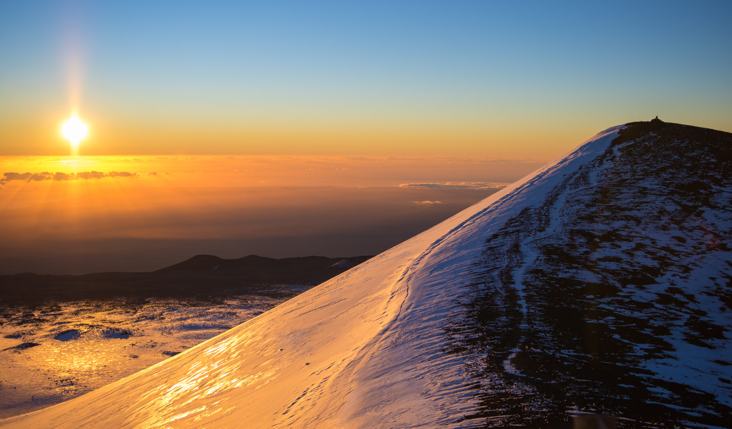 Mauna Kea on the Big Island of Hawaii — Mauna a Wākea — the highest point in Hawaii at 13803 feet and the world's tallest mountain measured from base to peak — sacred to Native Hawaiian Kānaka Maoli culture as the firstborn child of sky father Wākea and earth mother Papahānaumoku — showing the summit and observatory complex of one of the world's premier astronomical sites