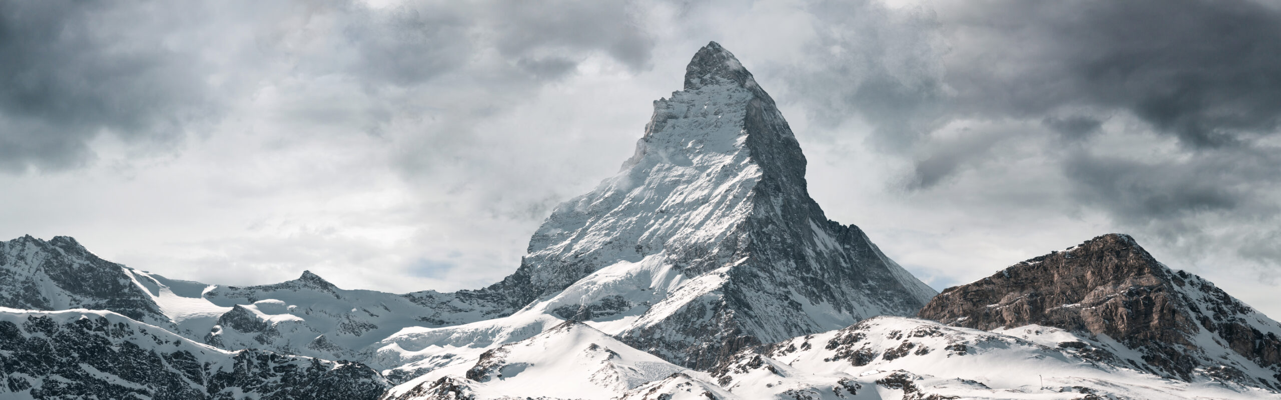 The Matterhorn at 4478 meters in the Pennine Alps on the Swiss-Italian border showing the iconic pyramidal silhouette of the mountain above Zermatt in canton Valais Switzerland — the most photographed mountain shape in the world and the climax of the 1865 Golden Age of Alpinism with the 14 July 1865 Edward Whymper first ascent