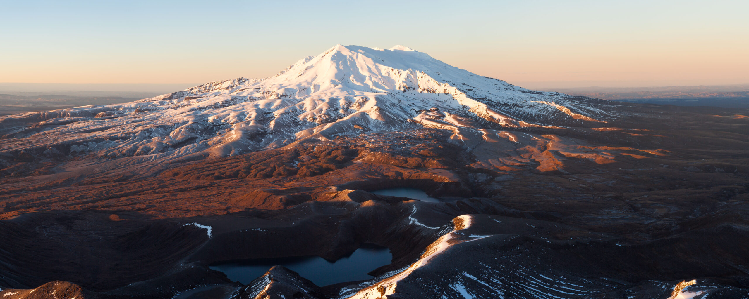 Mount Ruapehu in winter snow with the volcanic landscape of Tongariro National Park — North Island's highest peak, sacred to Ngāti Tūwharetoa, and centerpiece of NZ's first national park