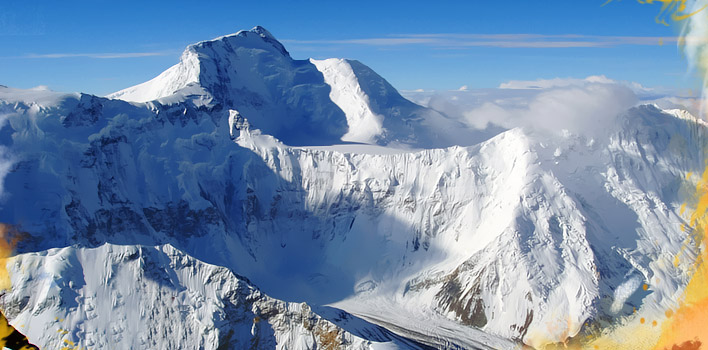Snow-covered Peak Korzhenevskaya in Tajikistan, showcasing rugged terrain and glacial features, representing a major 7,000-meter mountain for climbers.