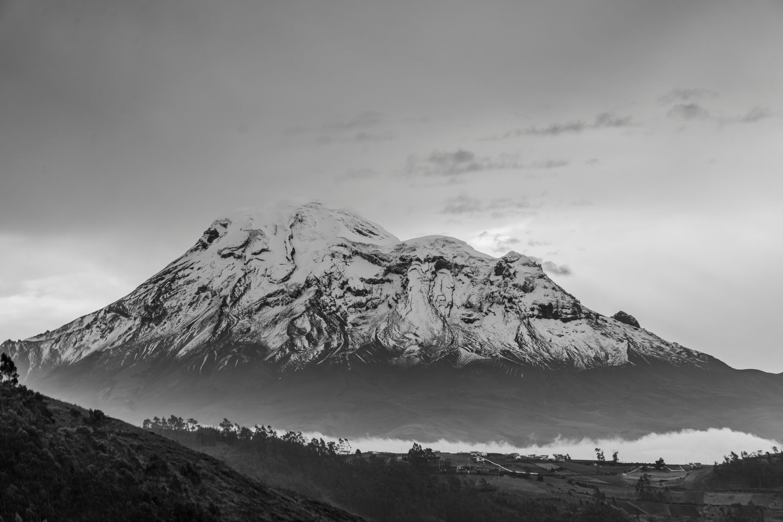 Chimborazo volcano in the Ecuadorian Andes — Taita Chimborazo — the highest mountain in Ecuador at 6263 meters and the closest point on Earth to the sun due to the planet's equatorial bulge — showing the massive snow-capped stratovolcano summit dominating the central Ecuadorian highlands approximately 150 km south-southwest of Quito
