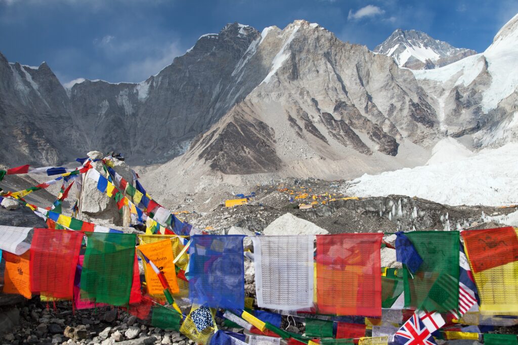 Panoramic view of major mountain ranges at sunset showing the scale of global mountaineering objectives across the Himalaya, Karakoram, Alps, Andes, Rockies, and Cascade ranges