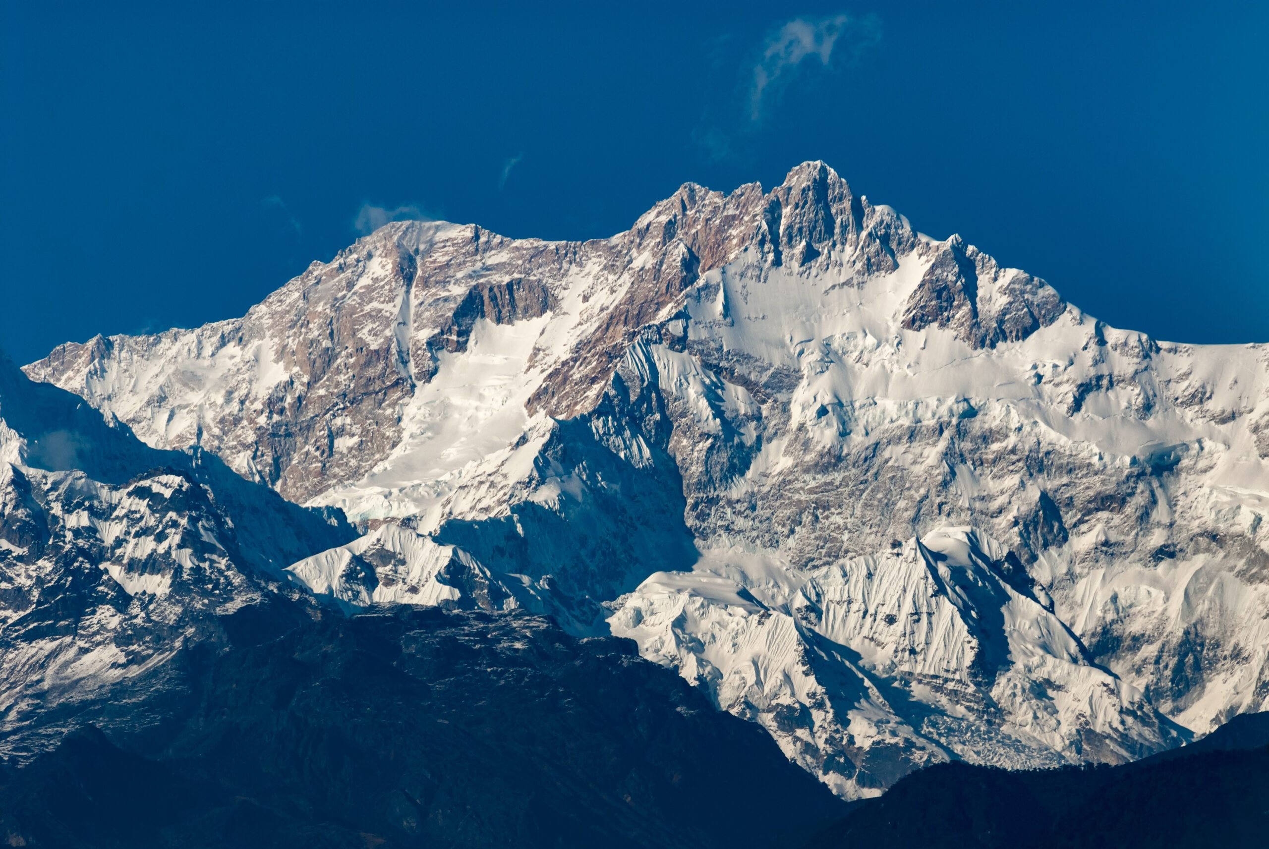 Snow-covered Kangchenjunga mountain peak, remote 8000er and challenging expedition.