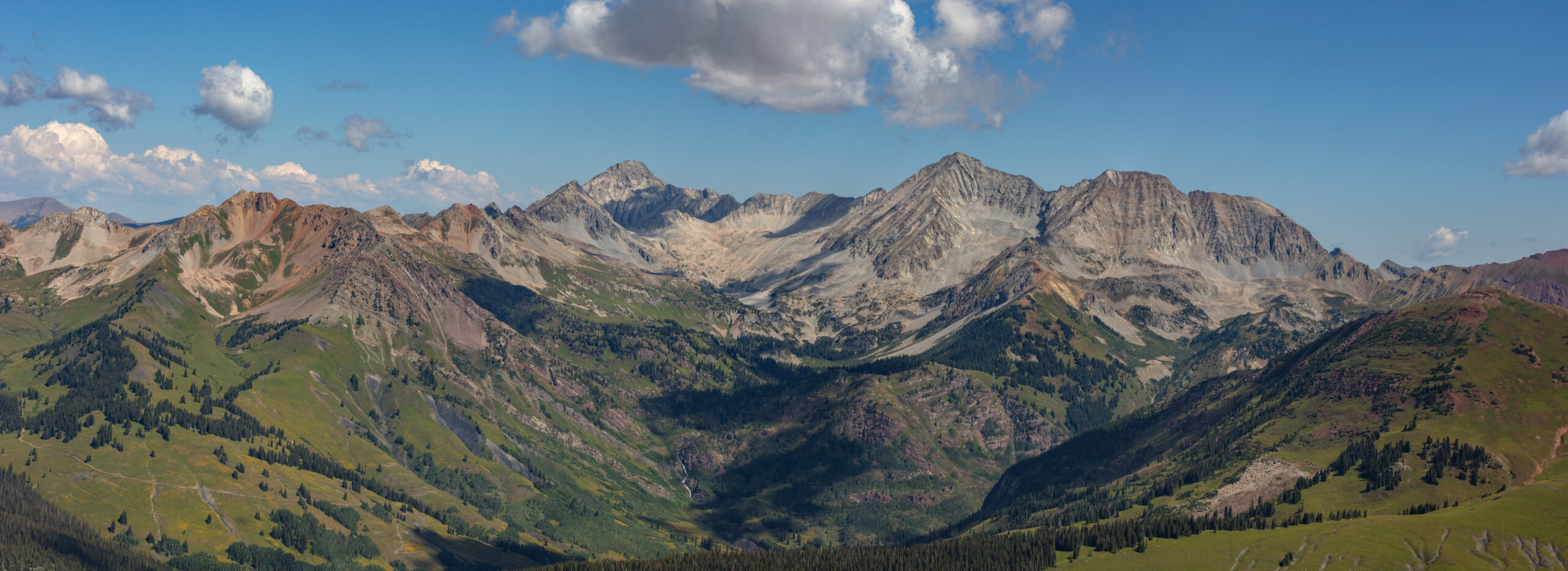 Capitol Peak at 14137 feet in Colorado Elk Mountains showing the dramatic summit ridge with the famous Knife Edge section visible from Capitol Lake during 2026 summer climbing season Snowmass Wilderness