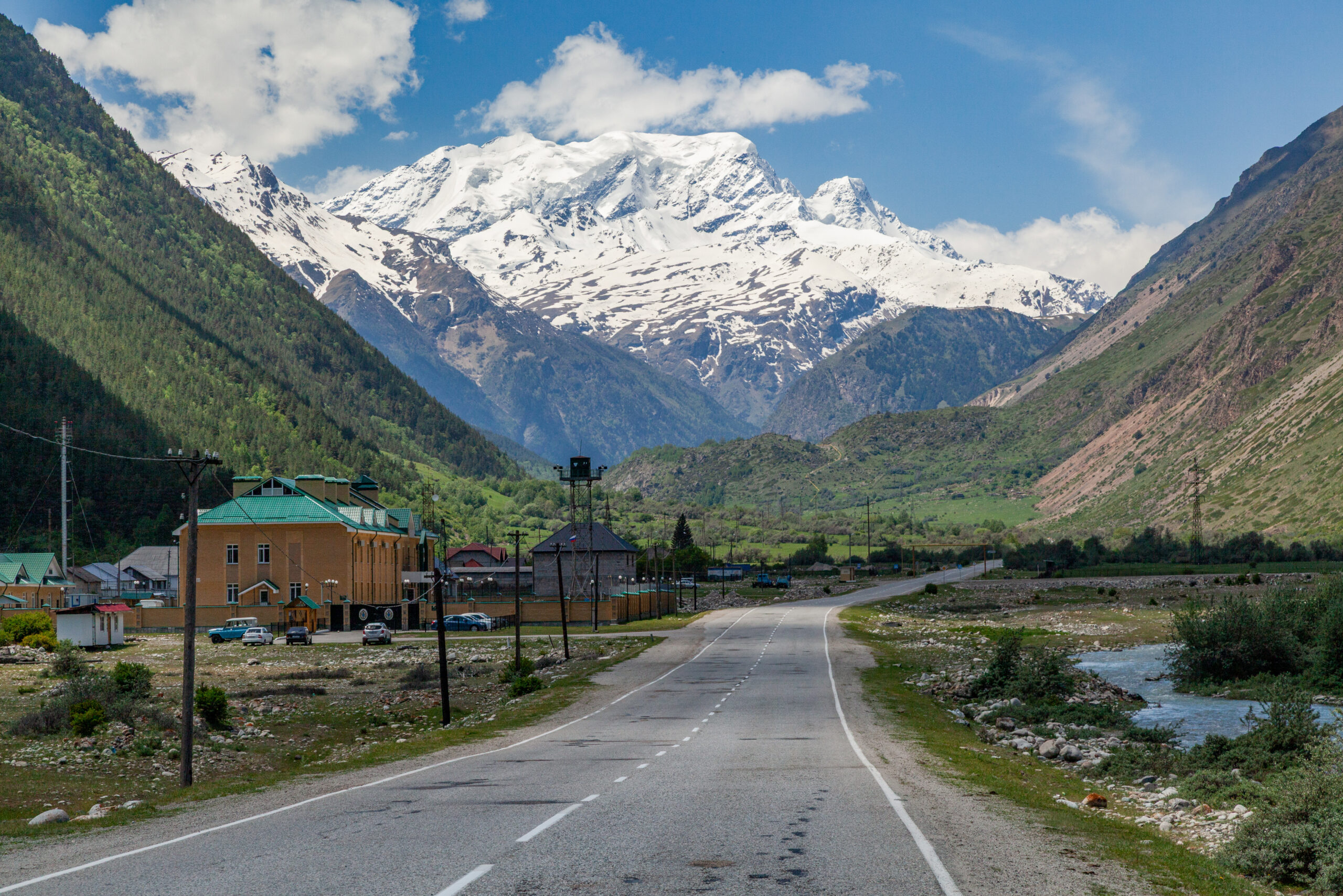 Mount Elbrus Caucasus Russia summit West East twin peak volcano cable car Barrel Huts Garabashi snow weather window June July climbing season success rate