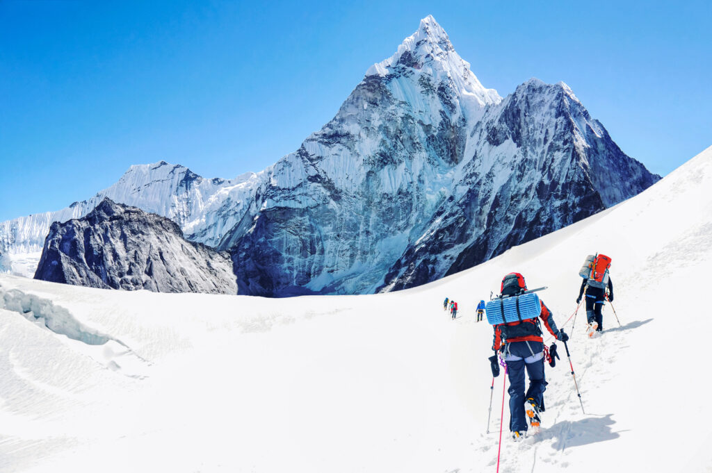 Snow-covered mountain peak and climbers ascending glacier illustrating summit success rates data.