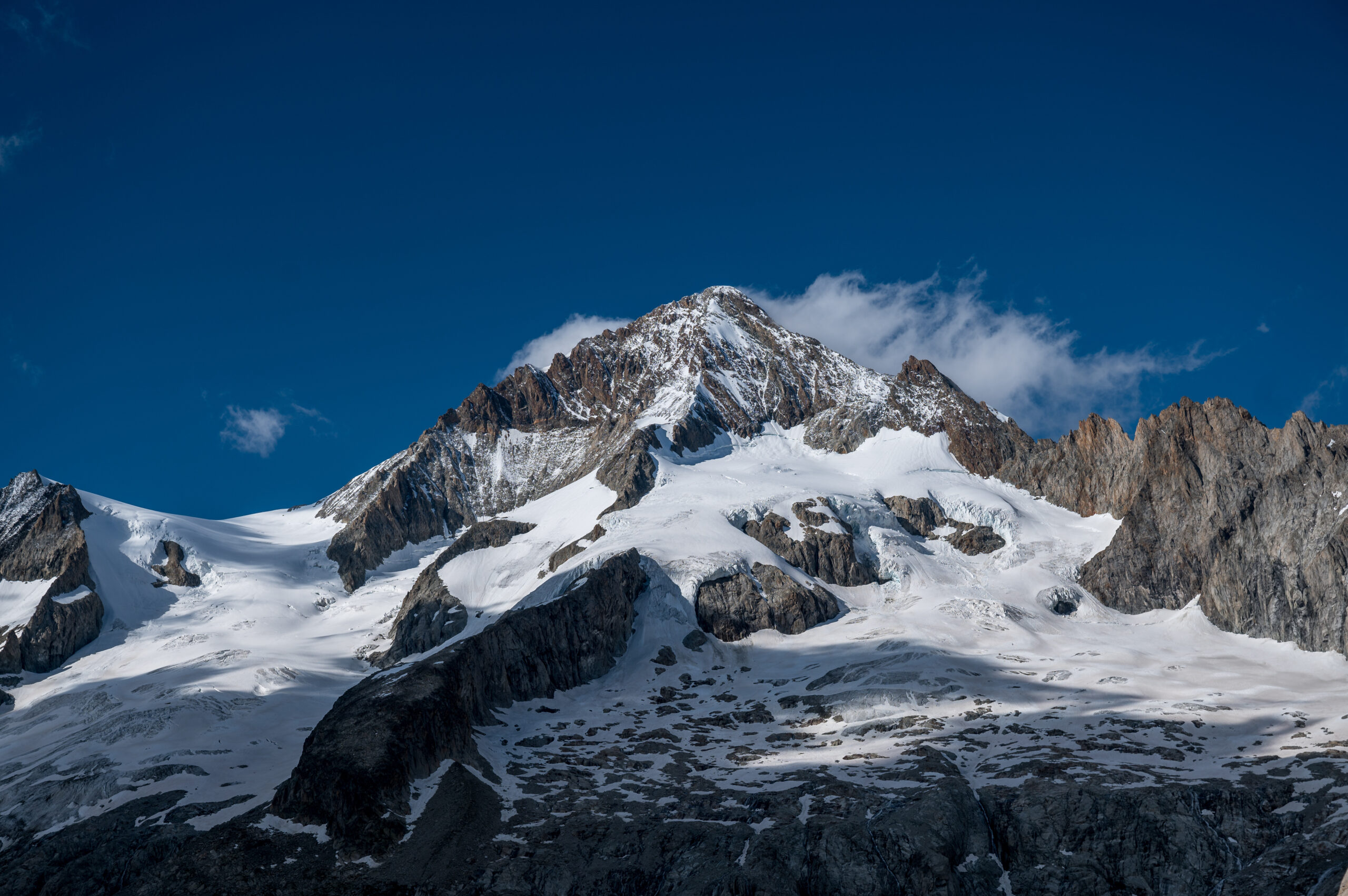 The Aletschhorn pyramid in the Bernese Alps of Switzerland, the second-highest peak of the Bernese Oberland, requiring B2 or B3 mountaineering boots, 12-point crampons, single technical ice axe, harness, helmet, 50 to 60 meter rope, and the wind-resistant layering system demanded by what is known as the coldest mountain in the Alps