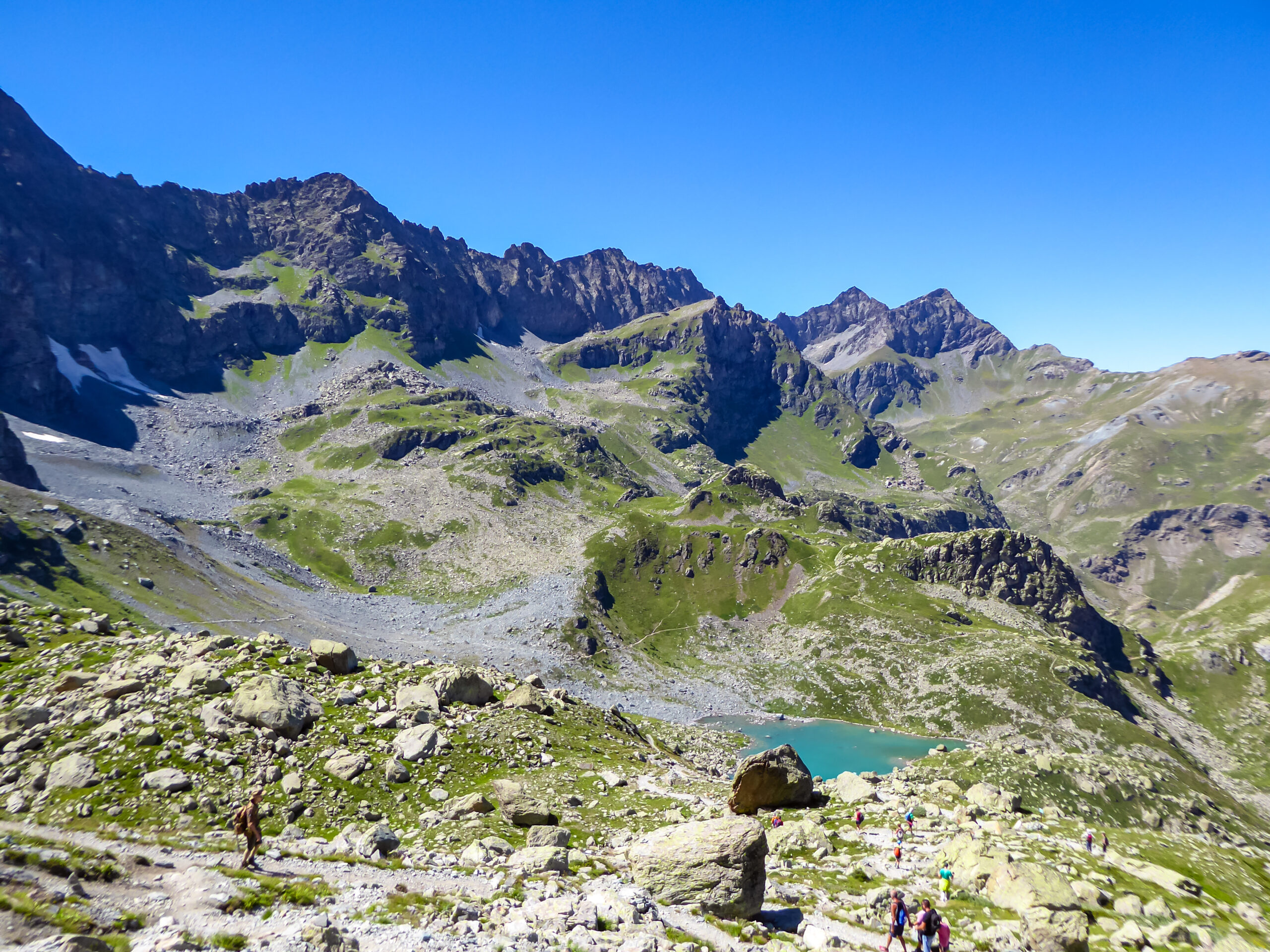 Monte Viso at 3841 meters showing the iconic isolated pyramidal silhouette rising above the Cottian Alps in Piedmont Italy with surrounding lower peaks visible from the Po Valley during 2026 summer climbing season
