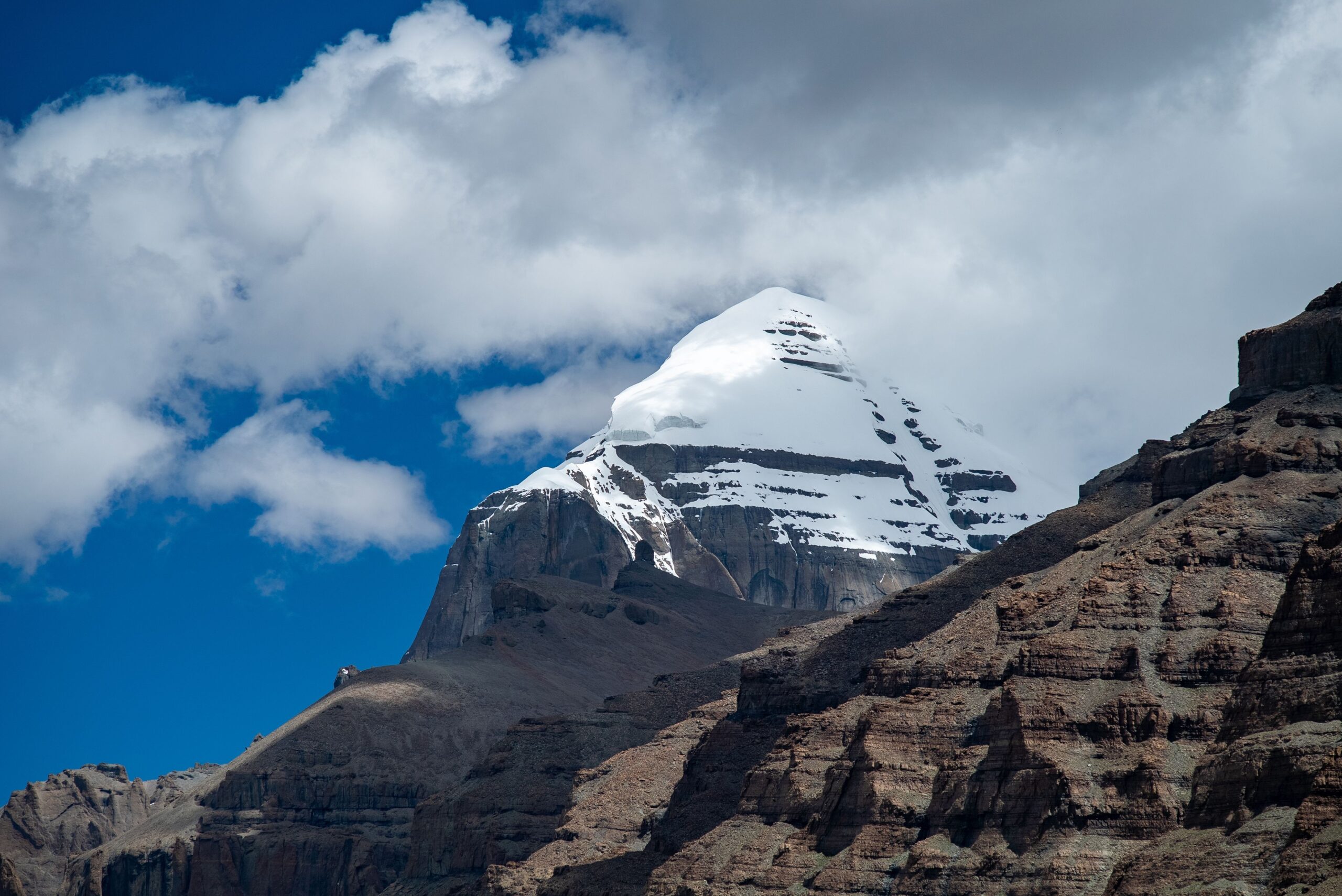 Mount Kailash with its snow-capped pyramidal peak rising above the Tibetan plateau — sacred mountain to Hindus, Buddhists, Jains, and Bon practitioners; never climbed