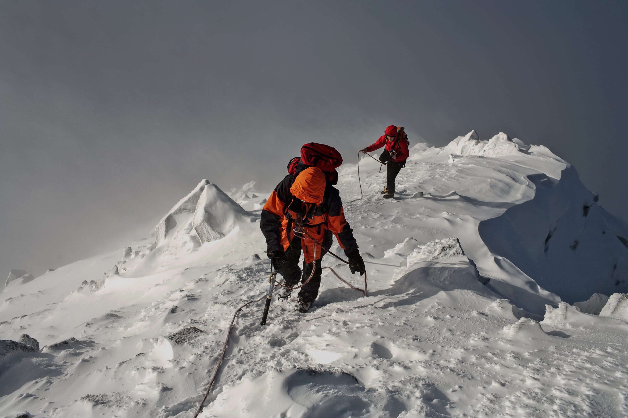 Climbing team moving together in high mountain terrain