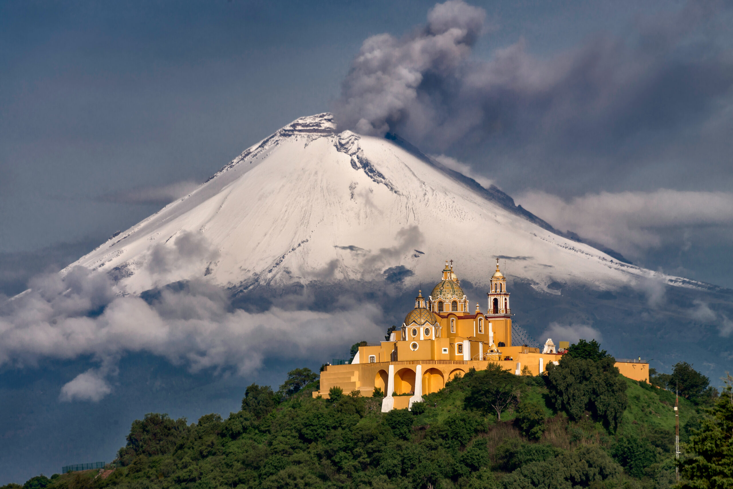 The Mexican high volcanoes of the Trans-Mexican Volcanic Belt showing the dramatic stratovolcano peaks that climbers attempt during the November to March climbing season including Pico de Orizaba Iztaccíhuatl La Malinche and Nevado de Toluca