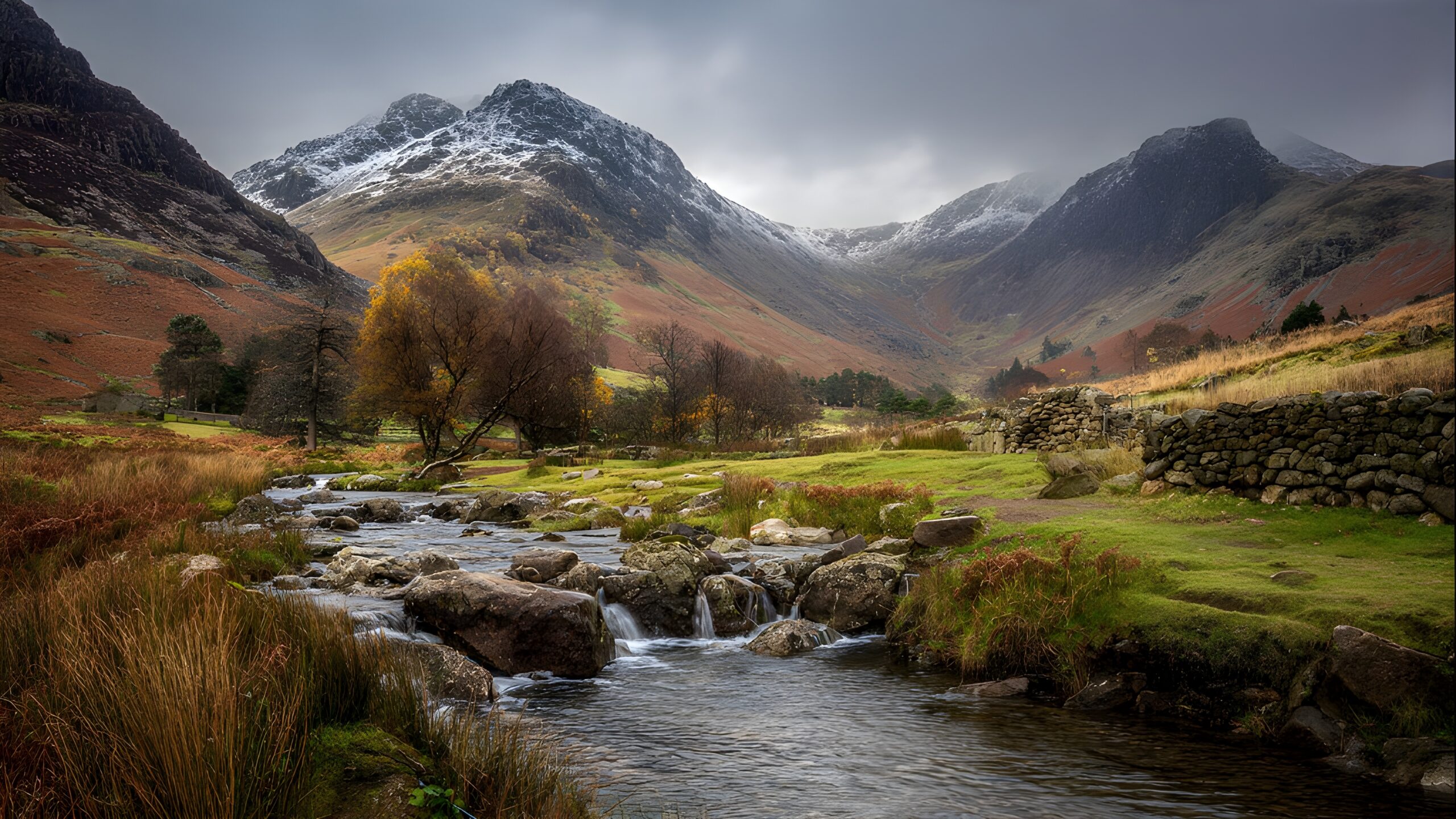 Breathtaking isolated serene unpopulated landscape showcasing the Lake District in northwestern England the home of Scafell Pike which is the highest peak in England at 978 meters elevation with its characteristic upland terrain rolling fells deep glacial lakes and the distinctive low-altitude alpine character that defines the major mountain country of England with the Wasdale Head approach to Scafell Pike being one of the standard routes used in the National Three Peaks Challenge representing one of the most photogenic and historically significant mountain regions in the British Isles