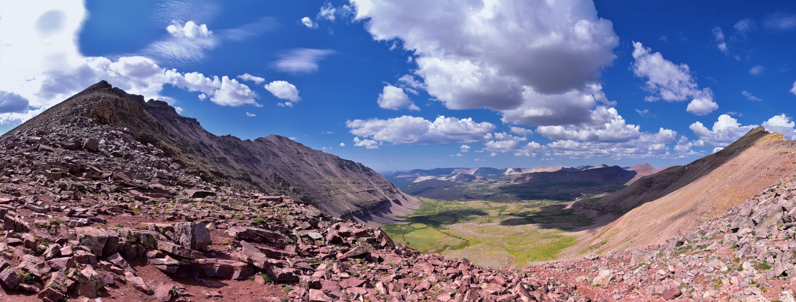 Alpine landscape view in the Uinta Mountains of northeastern Utah showing the dramatic high country terrain that surrounds Kings Peak at 13528 feet including the alpine basins above 10000 feet elevation rugged peaks of the High Uintas Wilderness Area exposed rocky ridges and basin lakes that characterize the area around Dollar Lake Henrys Fork Lake and the Henrys Fork Basin where Kings Peak hikers establish their basecamps before the summit day demonstrating why the High Uintas remains one of the most remote and pristine alpine wilderness areas in the continental United States and showing the kind of terrain that makes the 28.8 mile round trip backpacking effort to Utah's highest peak worthwhile