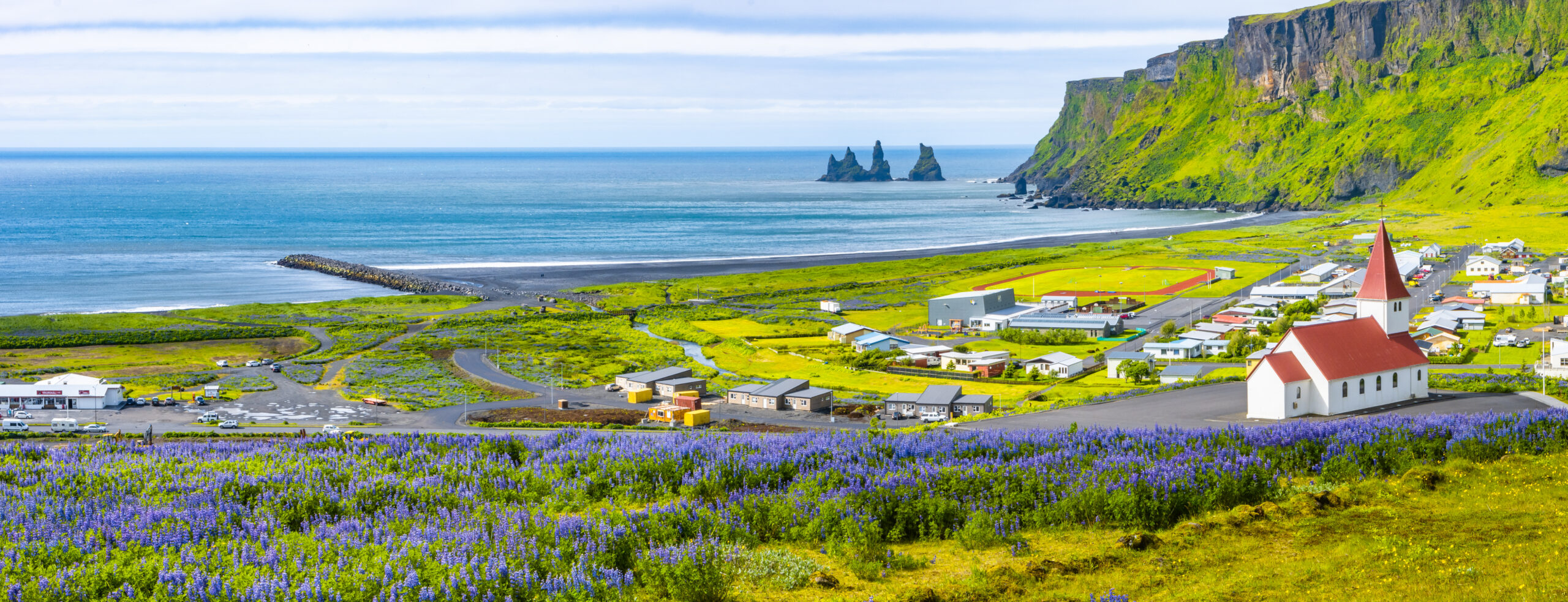 The south-coast town of Vik in Iceland beneath snow-dusted hills