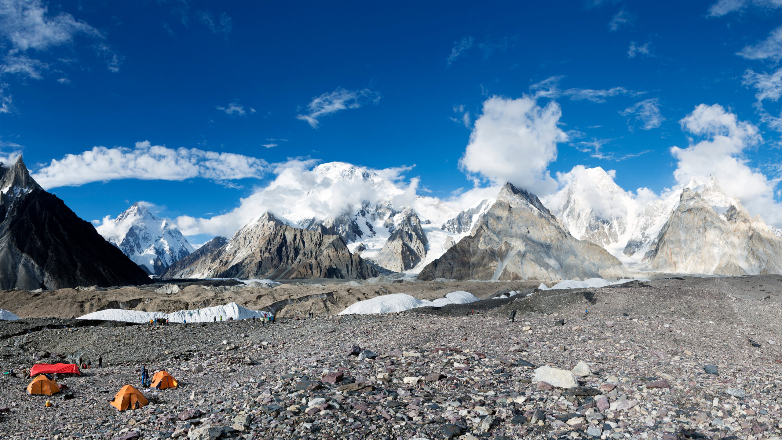 Steep glaciated high mountains under snow and cloud