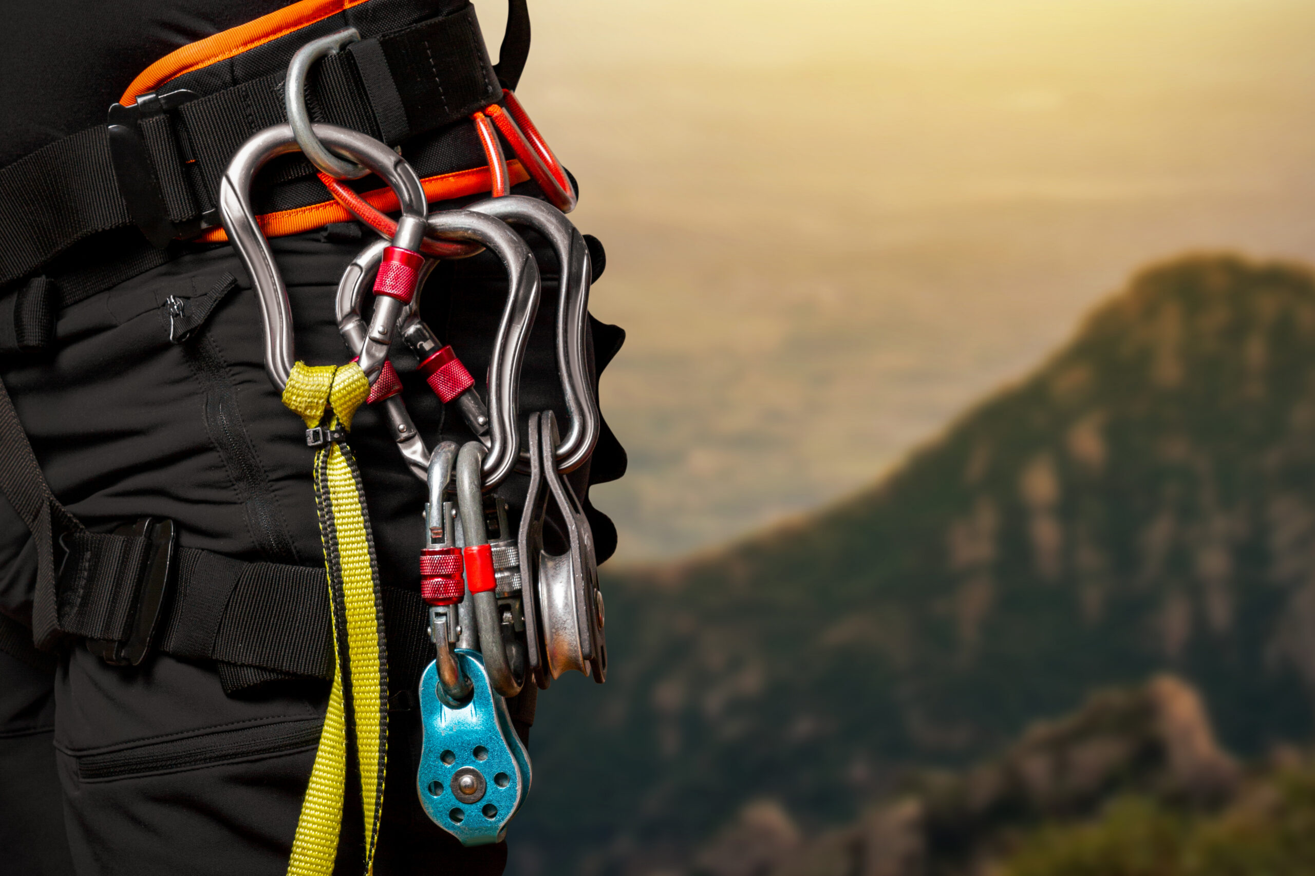 Climber checking the rappel system and rope ends before committing to the descent