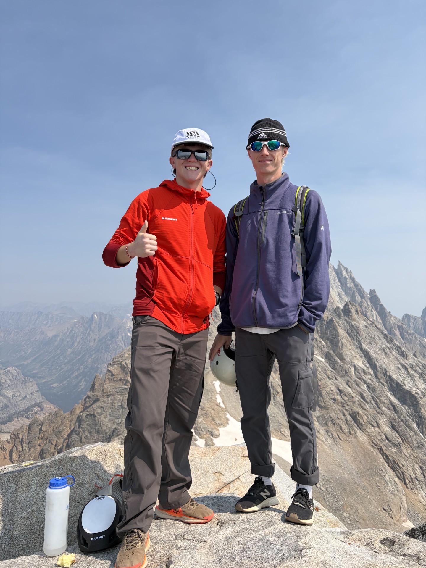 Dawson and a climbing partner with the rocky Teton skyline behind them