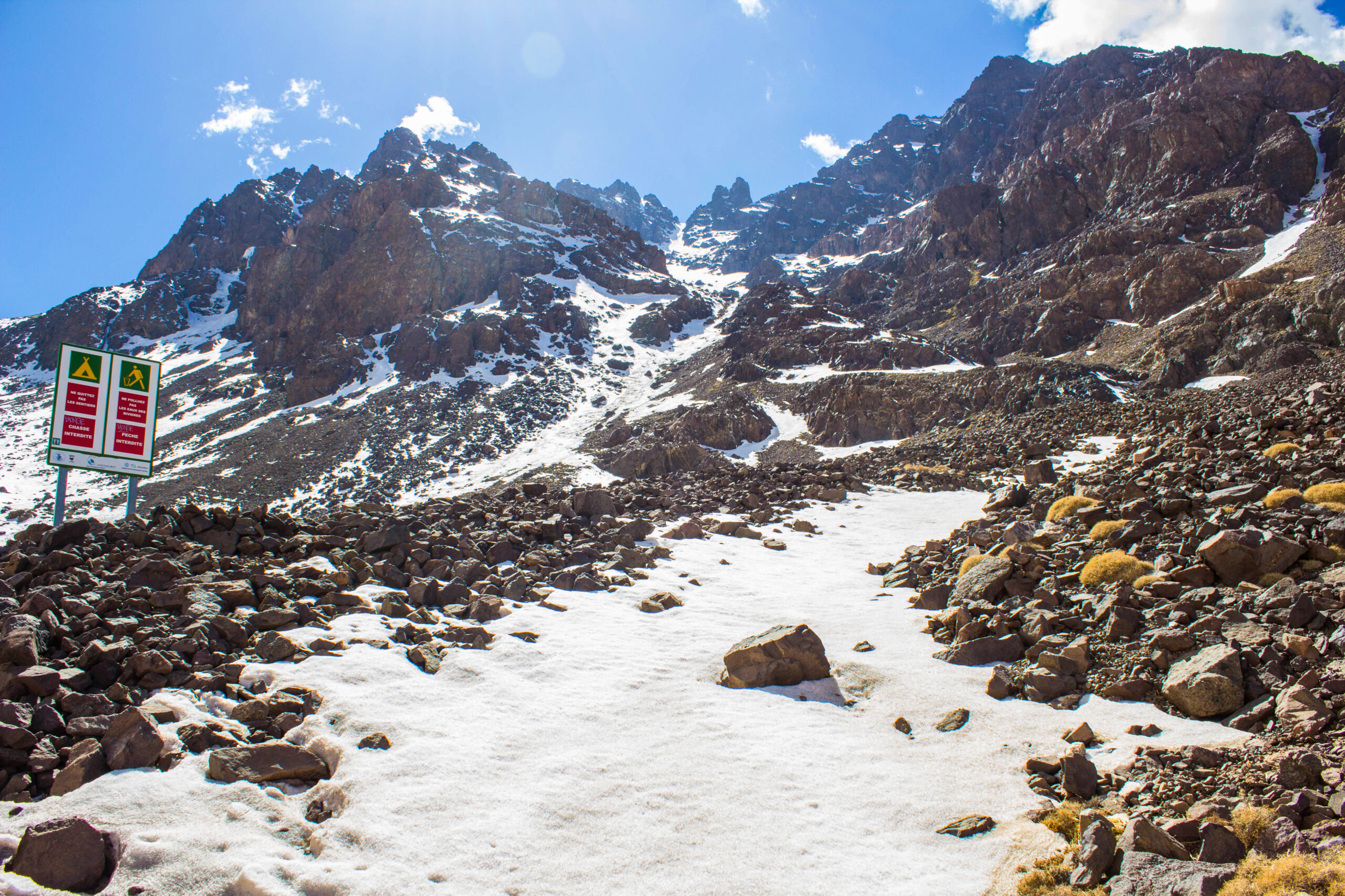 Trekkers and a local guide moving through Morocco's High Atlas Mountains on a guided Mount Toubkal journey